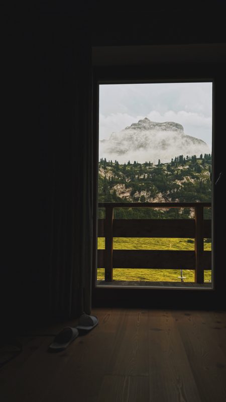 A peak wrapped in cloud, framed by the room window at Rifugio Fodara Vedla